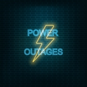 What is the difference between a blackout and a brownout in electricity terms?