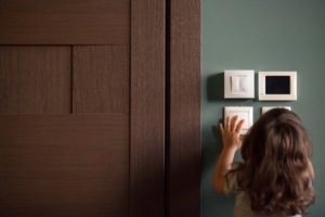 a little girl turns the lights off to save electricity during the lockdown