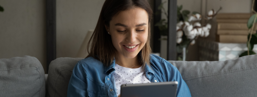 Young woman checks her prepaid electricity account balance on her ipad 